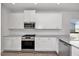 Bright kitchen featuring white cabinets, stainless steel appliances, and a granite countertop for a clean look at 4868 Pioneer Dr, Sanford, NC 27330