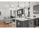 Modern kitchen open to living area with gray cabinets and white quartz countertops at 4868 Pioneer Dr, Sanford, NC 27330