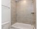 Clean bathroom with a shower-tub combination featuring neutral-toned tile at 10 Relaxing Way, Pittsboro, NC 27312