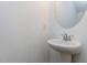 Modern half bath with pedestal sink and oval mirror at 10 Relaxing Way, Pittsboro, NC 27312