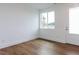 Bright, empty bedroom with a large window and wood floors, offering a clean and modern feel at 10 Relaxing Way, Pittsboro, NC 27312