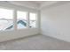 Bright bedroom with carpeted floors and large windows offering views of nearby rooftops at 10 Relaxing Way, Pittsboro, NC 27312