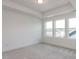 Cozy bedroom with carpeted floors and large windows overlooking the neighborhood at 10 Relaxing Way, Pittsboro, NC 27312