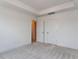 Bright carpeted bedroom with two doors, a tray ceiling, and recessed lighting at 10 Relaxing Way, Pittsboro, NC 27312