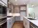 Well-equipped kitchen with gray cabinetry, stainless steel appliances, and a stylish central island at 10 Relaxing Way, Pittsboro, NC 27312