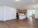Open-concept living room flows into a modern kitchen with an island and staircase nearby at 10 Relaxing Way, Pittsboro, NC 27312