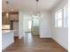 Open-concept living space showcasing hardwood floors, contemporary lighting and a clear view to the kitchen at 10 Relaxing Way, Pittsboro, NC 27312