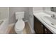 Bathroom featuring a white toilet, brown vanity and a sink with a white countertop at 10 Sandy Bluff Ct, Durham, NC 27703