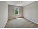 Cozy bedroom with carpet flooring, neutral walls, and natural light shining through the window at 10 Sandy Bluff Ct, Durham, NC 27703