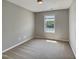 Minimalist bedroom featuring a large window providing natural light and outdoor views at 10 Sandy Bluff Ct, Durham, NC 27703