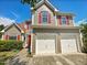 Charming two-story home featuring a two-car garage, red shutters, and a well-maintained front yard at 10 Sandy Bluff Ct, Durham, NC 27703