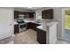 Bright kitchen featuring modern appliances, dark cabinets, and easy access to the outdoors at 10 Sandy Bluff Ct, Durham, NC 27703