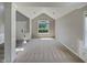 Bright living room with large window and neutral walls, perfect for relaxing or entertaining at 10 Sandy Bluff Ct, Durham, NC 27703