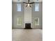 Open living area with a fireplace feature, large windows, and natural light at 10 Sandy Bluff Ct, Durham, NC 27703