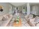 Bright, open living room with neutral tones, elegant decor, and a view into the dining area at 10 Sandy Bluff Ct, Durham, NC 27703
