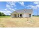Rear view showing the home's covered patio and surrounding green space at 1000 Peedin Rd, Selma, NC 27576