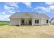 Back exterior view of the home highlighting a covered patio and several windows at 1000 Peedin Rd, Selma, NC 27576