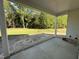 Covered back porch that overlooks a large yard with lush trees providing a serene backdrop at 1000 Peedin Rd, Selma, NC 27576