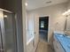 This bathroom features a shower and a soaking tub with tons of natural light pouring in from the large windows at 1000 Peedin Rd, Selma, NC 27576
