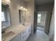 Elegant bathroom with double sinks, quartz countertops, white cabinets, and a walk-in shower at 1000 Peedin Rd, Selma, NC 27576