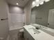 Clean bathroom with a shower and tub combo, white vanity, and decorative lighting at 1000 Peedin Rd, Selma, NC 27576