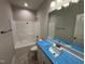 Bathroom featuring a shower-tub combo, hexagon tile floors, and a modern vanity at 1000 Peedin Rd, Selma, NC 27576