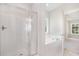 Bathroom featuring a shower, soaker tub, and natural light from a window above the tub at 1000 Peedin Rd, Selma, NC 27576