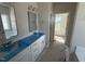 Bathroom with double vanity sinks, modern fixtures, and a large mirror at 1000 Peedin Rd, Selma, NC 27576