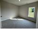 Cozy bedroom with plush carpeting, neutral paint, a bright window, and ample natural light at 1000 Peedin Rd, Selma, NC 27576