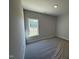 A bright bedroom with carpet and large windows offering pleasant views at 1000 Peedin Rd, Selma, NC 27576