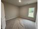 Bright bedroom with natural light and carpet flooring, creating a cozy and comfortable space for rest and relaxation at 1000 Peedin Rd, Selma, NC 27576