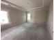 Well-lit bedroom featuring a large window and neutral walls, offering a serene retreat at 1000 Peedin Rd, Selma, NC 27576