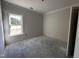 Well-lit bedroom featuring a large window and neutral walls, offering a serene retreat at 1000 Peedin Rd, Selma, NC 27576