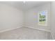 This bedroom features neutral carpet and natural light from a window at 1000 Peedin Rd, Selma, NC 27576
