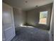 Unfinished bedroom featuring a bright window and natural light, ready to be customized at 1000 Peedin Rd, Selma, NC 27576