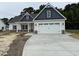 Charming two-story home with a spacious two car garage and a well-manicured lawn and inviting front porch at 1000 Peedin Rd, Selma, NC 27576