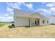 Rear exterior showcasing a well-maintained home with a covered patio and ample backyard space at 1000 Peedin Rd, Selma, NC 27576