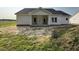 View of the home's rear with a covered porch and large windows offering views and natural light at 1000 Peedin Rd, Selma, NC 27576