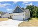 Attached two-car garage with modern doors, lighting, and extended driveway at 1000 Peedin Rd, Selma, NC 27576