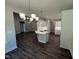 Open-concept kitchen showcases modern white cabinets, a large island, and stainless steel appliances at 1000 Peedin Rd, Selma, NC 27576