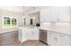 Bright kitchen boasts quartz countertops, stainless steel appliances, and an undermount sink with stylish pendant lighting at 1000 Peedin Rd, Selma, NC 27576
