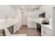 Modern kitchen featuring white cabinets, stainless steel appliances, and sleek countertops and backsplash at 1000 Peedin Rd, Selma, NC 27576