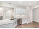 Bright kitchen with stainless steel appliances, quartz countertops, undermount sink, and open view into the living room at 1000 Peedin Rd, Selma, NC 27576