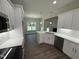Modern kitchen features stainless steel appliances, white cabinetry, and island with a sink at 1000 Peedin Rd, Selma, NC 27576