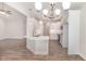 Open kitchen with stainless steel appliances, eat-in bar, pendant lights and wood-look floors is perfect for entertaining at 1000 Peedin Rd, Selma, NC 27576