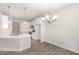 Well-lit eat-in kitchen featuring white cabinets, stainless appliances, pendant lighting and durable wood-look floors at 1000 Peedin Rd, Selma, NC 27576