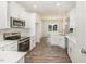 Bright kitchen featuring stainless steel appliances, granite countertops, and custom cabinetry at 1000 Peedin Rd, Selma, NC 27576