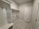 Functional laundry room with stylish floors, storage, coat hooks, and convenient access at 1000 Peedin Rd, Selma, NC 27576