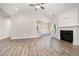 Open-concept living area with wood floors, fireplace, and access to the kitchen and dining area at 1000 Peedin Rd, Selma, NC 27576