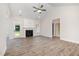 Bright living room with a fireplace, ceiling fan, and luxury vinyl flooring at 1000 Peedin Rd, Selma, NC 27576